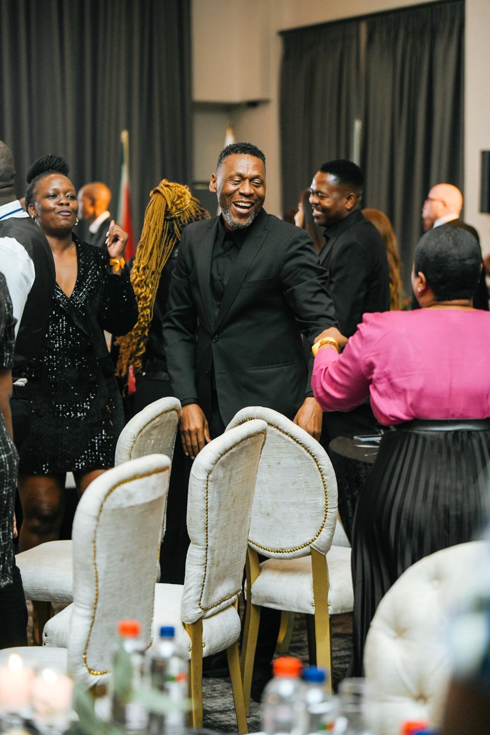 Guest laughing among the gold-trimmed chairs