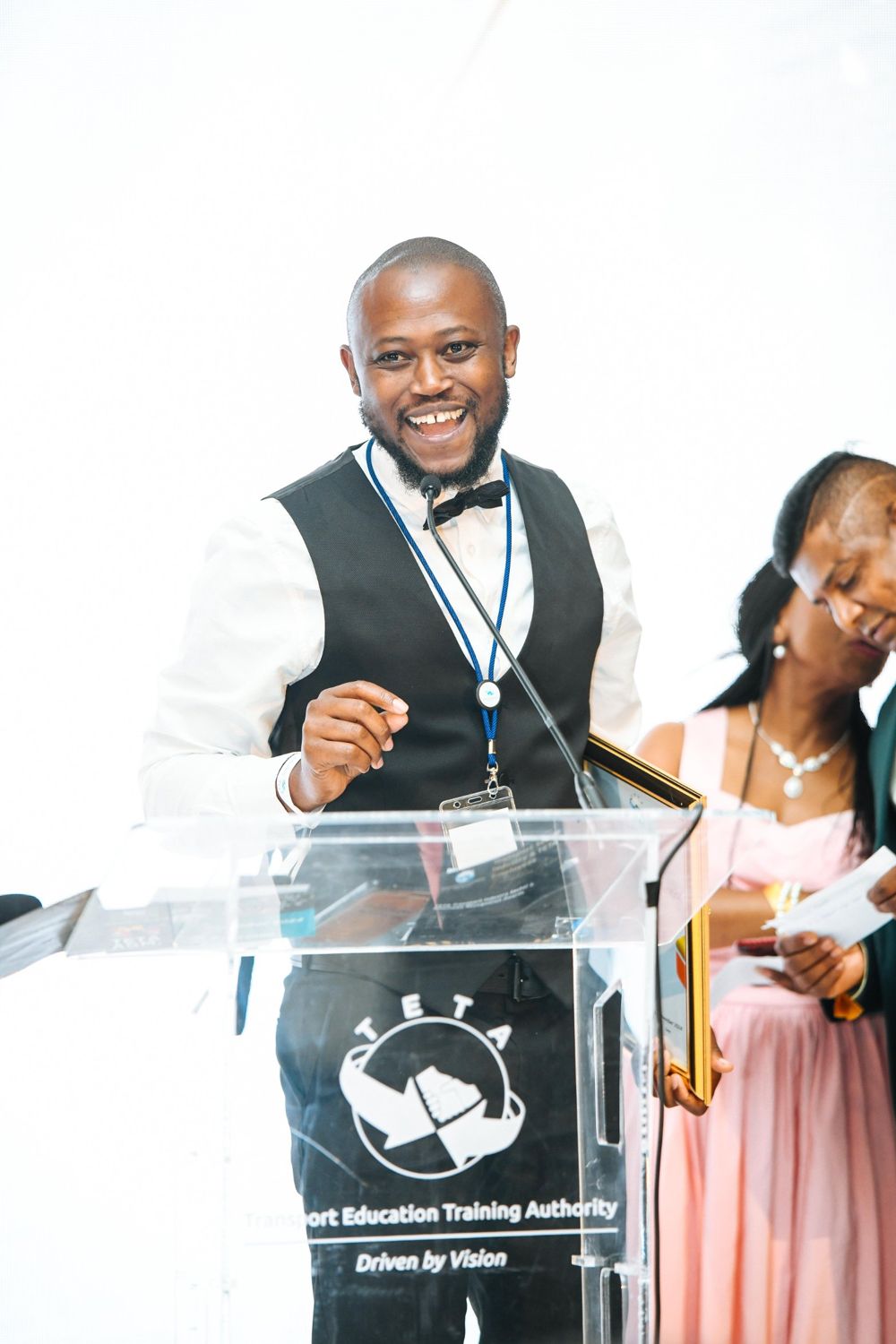 Smiling winner speaking at the TETA podium
