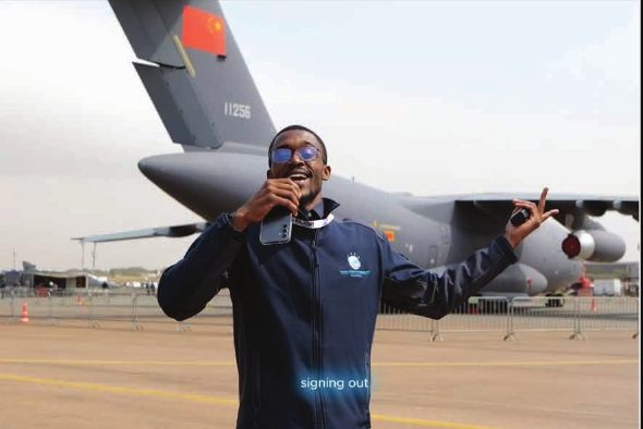 Wandii presenting on camera in front of a cargo aircraft at AAD 2024