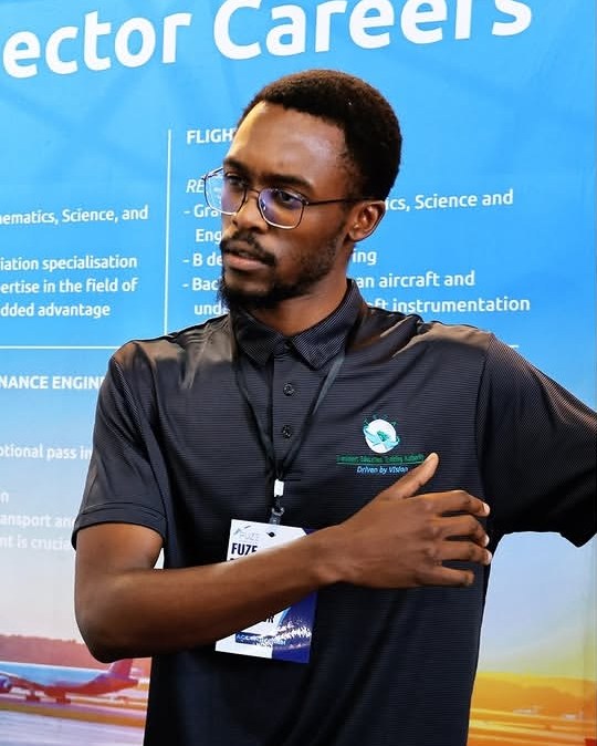 Wandii at the TETA stand at the Fuze Pietermaritzburg Airshow, in front of an aviation careers banner